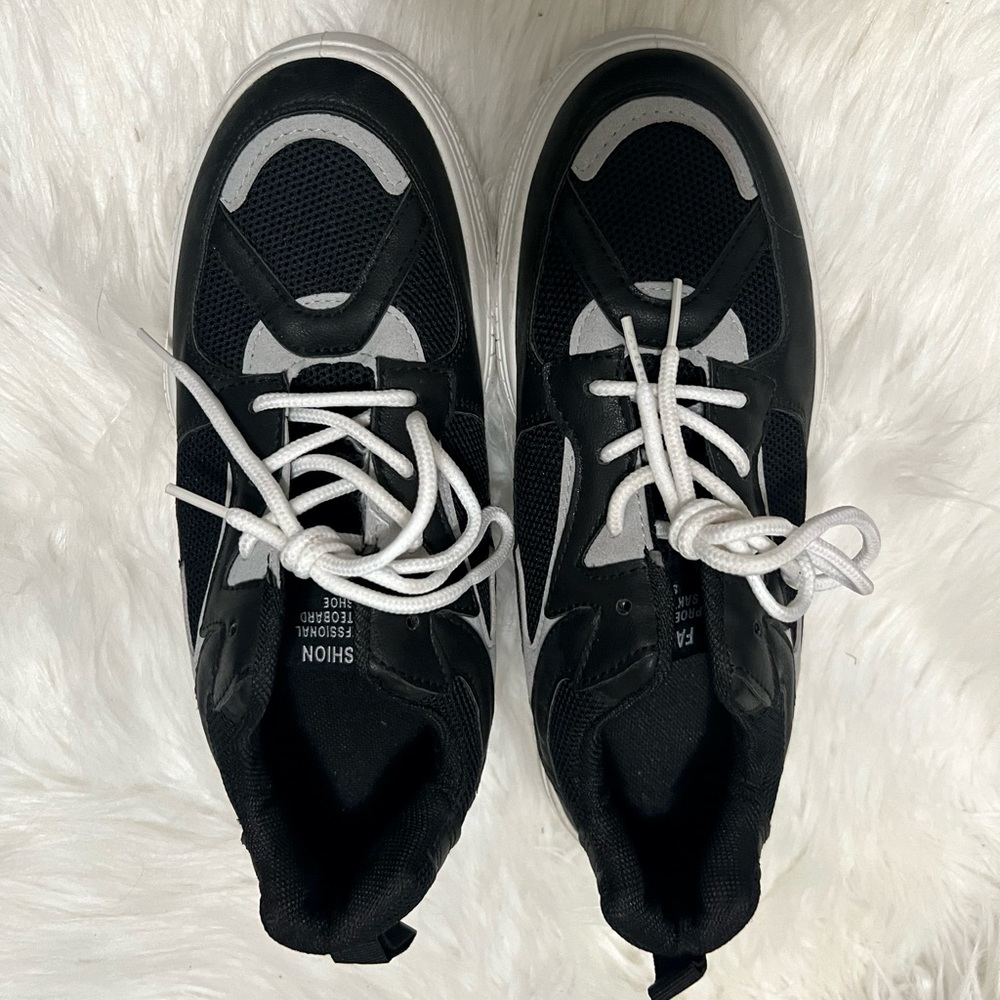 Black and grey sneakers with white lace